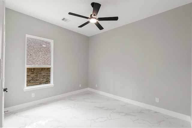 3518 Misty Moss, Montgomery, TX 77356 - spare room with marble look tile flooring, a ceiling fan, and baseboards