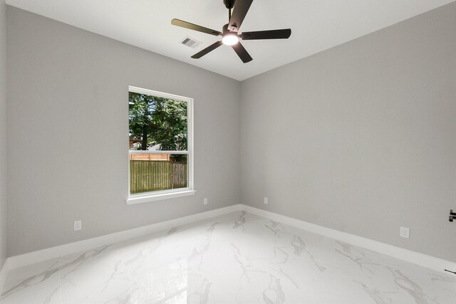 3518 Misty Moss, Montgomery, TX 77356 - spare room with marble look tile flooring, baseboards, and a ceiling fan