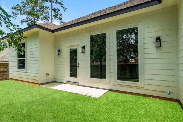 3518 Misty Moss, Montgomery, TX 77356 - rear view of house featuring a lawn