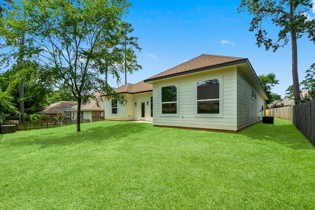 3518 Misty Moss, Montgomery, TX 77356 - rear view of property featuring a shingled roof and cooling unit