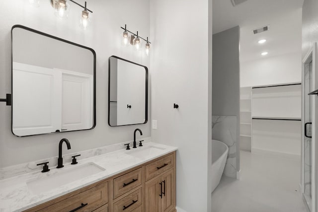 3518 Misty Moss, Montgomery, TX 77356 - full bath with double vanity, a freestanding tub, a walk in closet, and recessed lighting