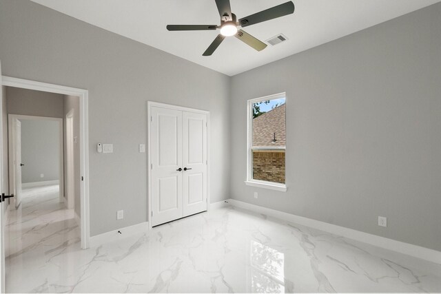 3518 Misty Moss, Montgomery, TX 77356 - unfurnished bedroom with marble tiled flooring, baseboards, a ceiling fan, and a closet