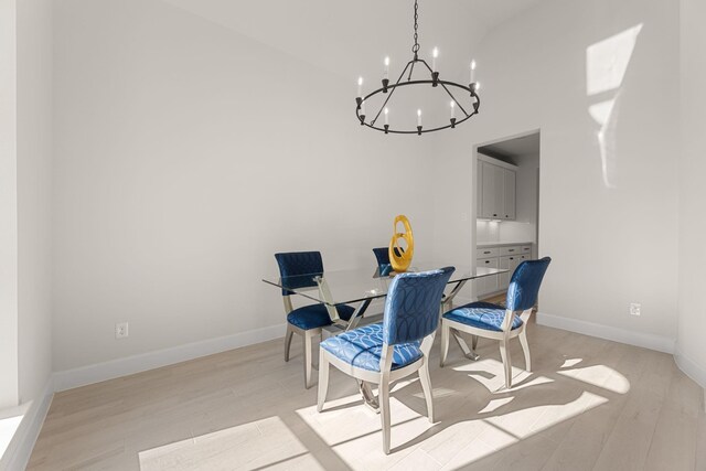 454 Patina Dr, Montgomery, TX 77316 - dining area with light wood-style flooring, a chandelier, a high ceiling, and baseboards