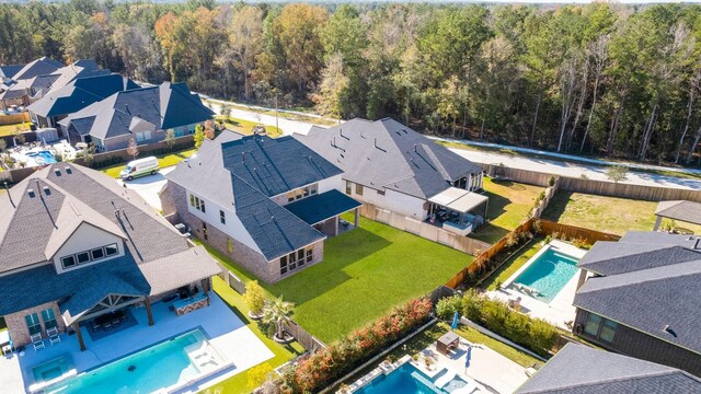454 Patina Dr, Montgomery, TX 77316 - aerial view of residential area featuring a pool area and a heavily wooded area