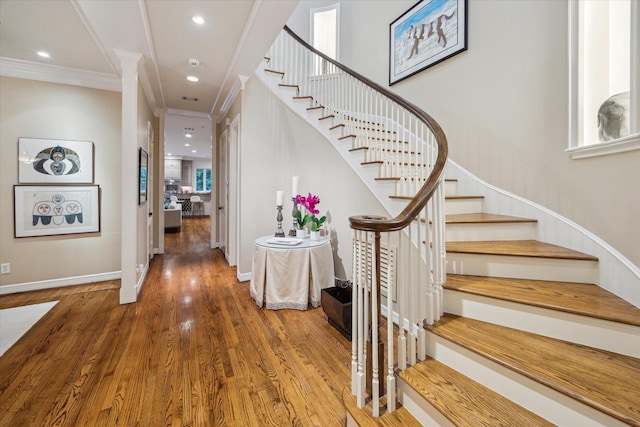5710 Logan Ln, Houston, TX 77007 - stairway with wood finished floors, ornamental molding, recessed lighting, and baseboards