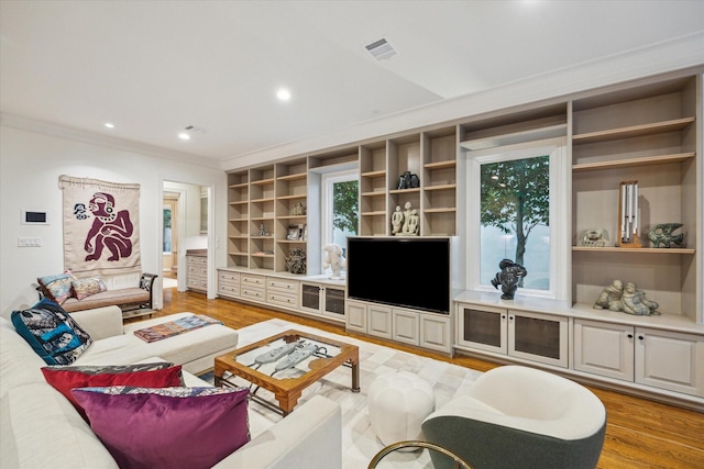 5710 Logan Ln, Houston, TX 77007 - living area featuring ornamental molding, light wood-type flooring, recessed lighting, and built in shelves