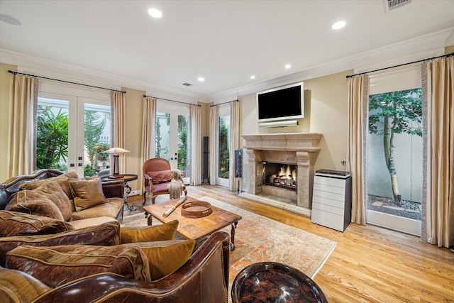 5710 Logan Ln, Houston, TX 77007 - living room with french doors, ornamental molding, wood finished floors, a fireplace, and recessed lighting