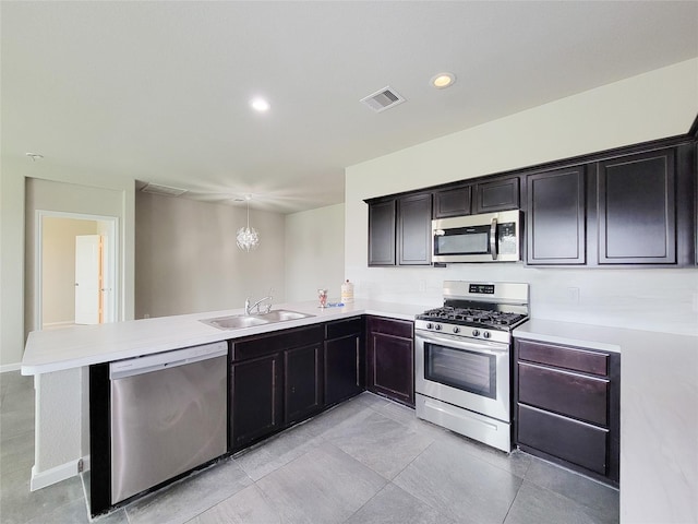 5426 Redwood Summit Ln, Katy, TX 77449 - kitchen with stainless steel appliances, a peninsula, light countertops, recessed lighting, and light tile patterned floors