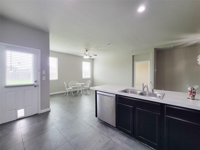 5426 Redwood Summit Ln, Katy, TX 77449 - kitchen featuring stainless steel dishwasher, light countertops, dark cabinetry, and light tile patterned floors