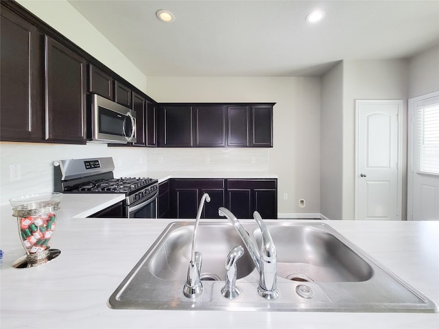 5426 Redwood Summit Ln, Katy, TX 77449 - kitchen featuring stainless steel appliances, light countertops, recessed lighting, and dark brown cabinetry