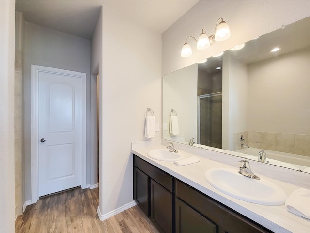 5426 Redwood Summit Ln, Katy, TX 77449 - full bath featuring double vanity, a shower stall, wood finished floors, and a garden tub
