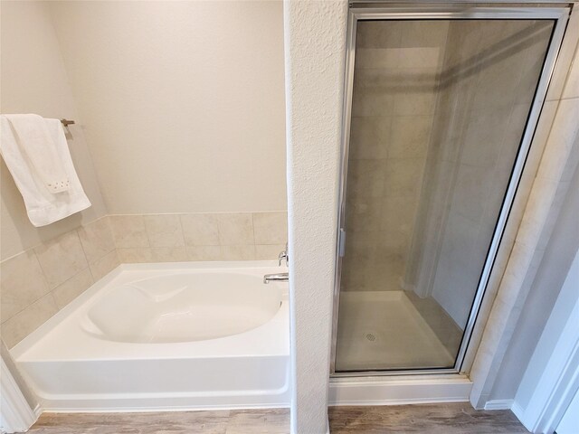 5426 Redwood Summit Ln, Katy, TX 77449 - bathroom featuring a bath, a stall shower, and wood finished floors
