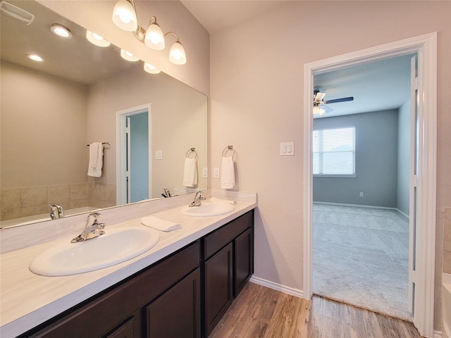 5426 Redwood Summit Ln, Katy, TX 77449 - bathroom featuring double vanity, a tub to relax in, wood finished floors, and ceiling fan