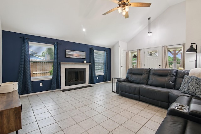5551 Fawn Trail Ln, Humble, TX 77346 - living room with ceiling fan, light tile patterned floors, high vaulted ceiling, and a fireplace