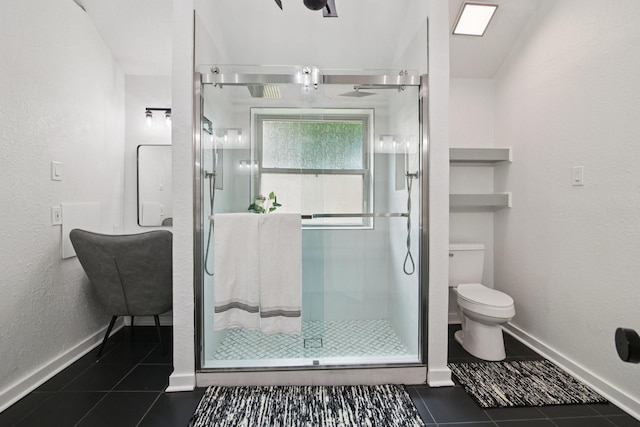 5551 Fawn Trail Ln, Humble, TX 77346 - bathroom with tile patterned flooring, toilet, a stall shower, and baseboards