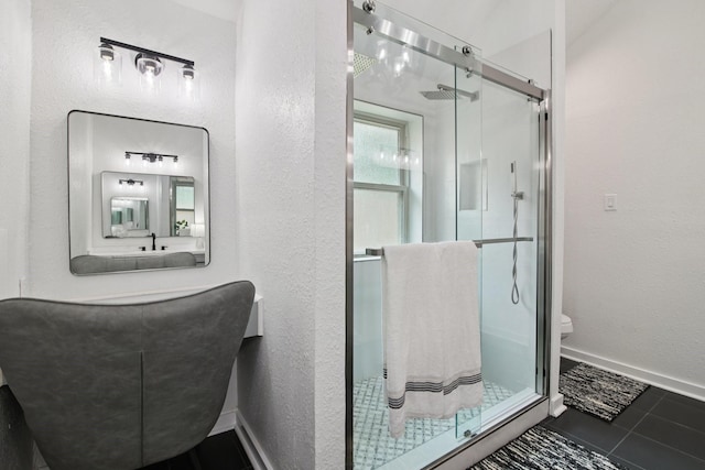 5551 Fawn Trail Ln, Humble, TX 77346 - full bathroom featuring a stall shower, toilet, tile patterned flooring, a textured wall, and baseboards