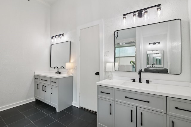 5551 Fawn Trail Ln, Humble, TX 77346 - full bathroom with two vanities, tile patterned flooring, baseboards, and a textured wall