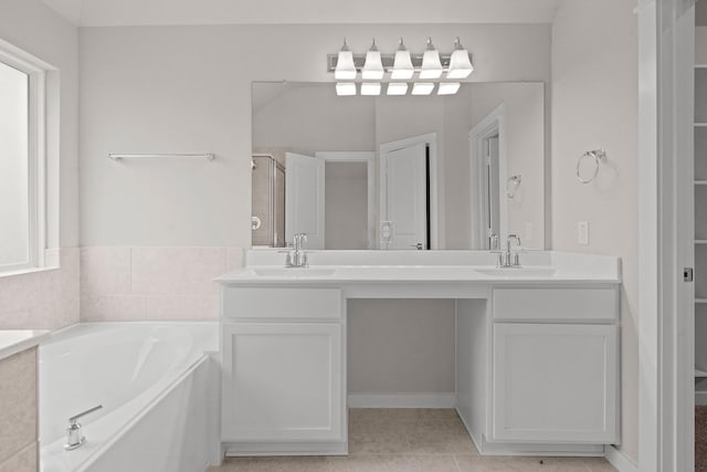207 Little Dog Dr, Montgomery, TX 77356 - bathroom featuring double vanity, a bath, a shower with shower door, and tile patterned floors