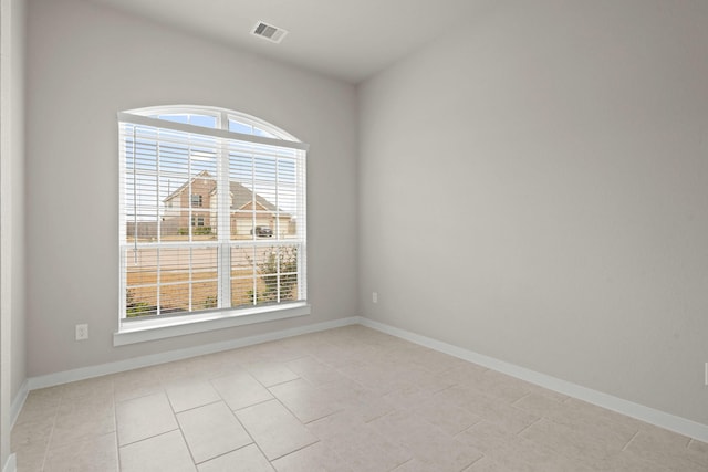 207 Little Dog Dr, Montgomery, TX 77356 - spare room featuring healthy amount of natural light, baseboards, and light tile patterned floors