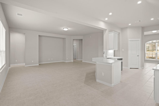 207 Little Dog Dr, Montgomery, TX 77356 - kitchen featuring a sink, light countertops, white cabinetry, recessed lighting, and a peninsula