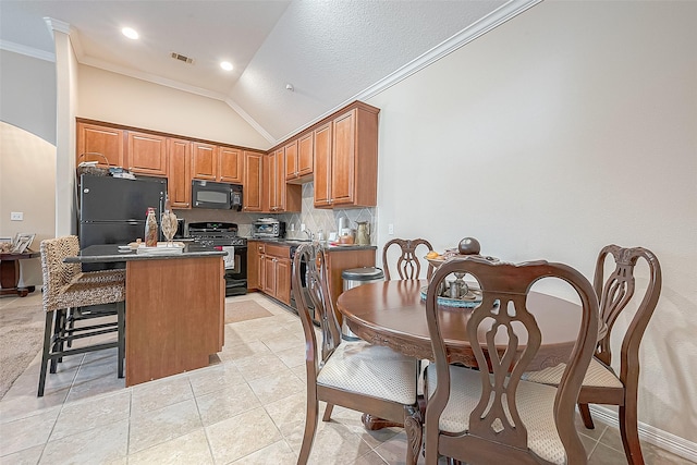 20904 Sunrise Pine View Ln, Katy, TX 77450 - kitchen with black appliances, dark countertops, lofted ceiling, a kitchen island, and decorative backsplash
