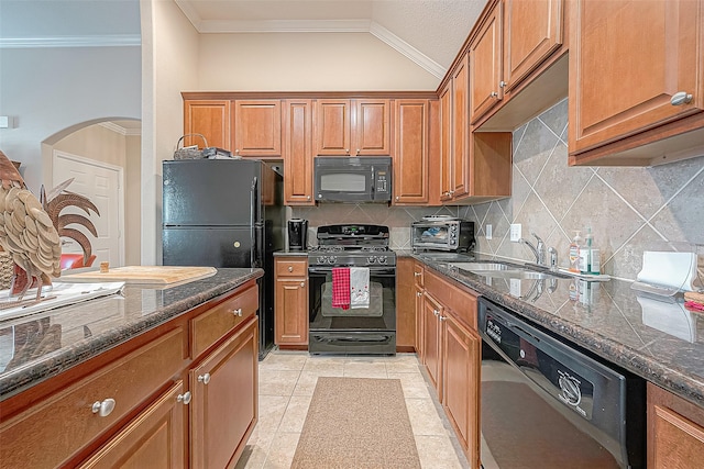 20904 Sunrise Pine View Ln, Katy, TX 77450 - kitchen featuring black appliances, crown molding, a sink, brown cabinets, and arched walkways
