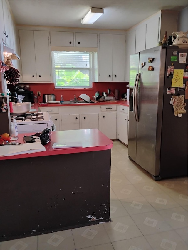 526 Guyer St, Sugar Land, TX 77498 - kitchen with stainless steel refrigerator with ice dispenser, a peninsula, a sink, white cabinets, and light tile patterned flooring