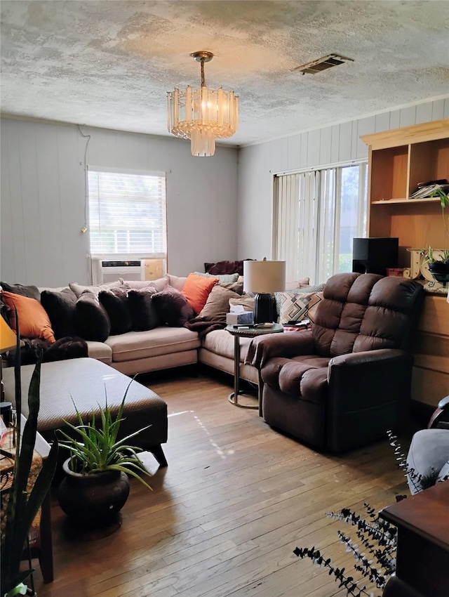 526 Guyer St, Sugar Land, TX 77498 - living area featuring a chandelier, plenty of natural light, hardwood / wood-style floors, and a textured ceiling