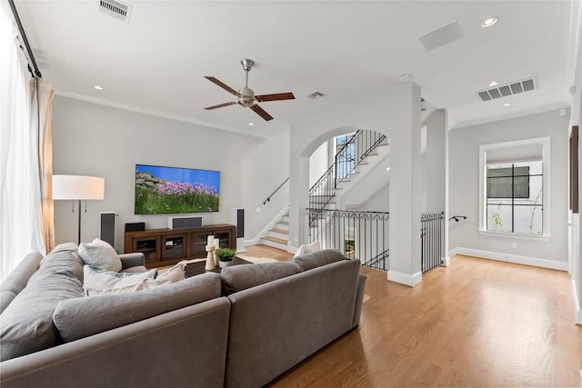 1705 Michigan St, Houston, TX 77006 - living room featuring light wood-style flooring, ceiling fan, recessed lighting, baseboards, and ornamental molding