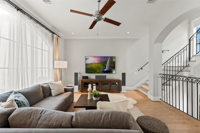1705 Michigan St, Houston, TX 77006 - living area featuring ceiling fan, light wood-style flooring, stairway, arched walkways, and recessed lighting