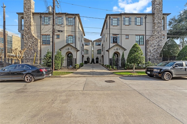 1705 Michigan St, Houston, TX 77006 - view of front of home with stucco siding, a gate, and a chimney
