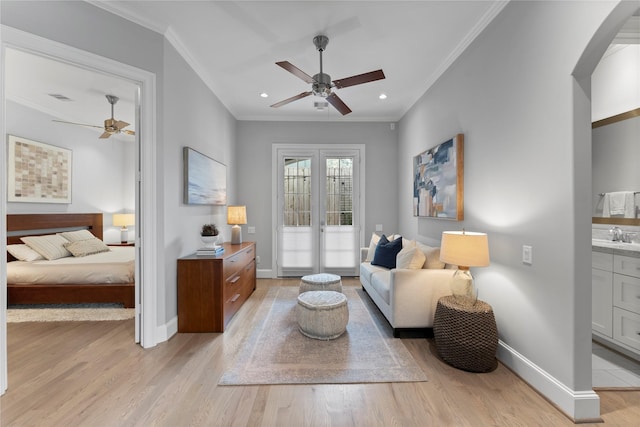 1705 Michigan St, Houston, TX 77006 - sitting room featuring ceiling fan, crown molding, arched walkways, light wood-style floors, and baseboards