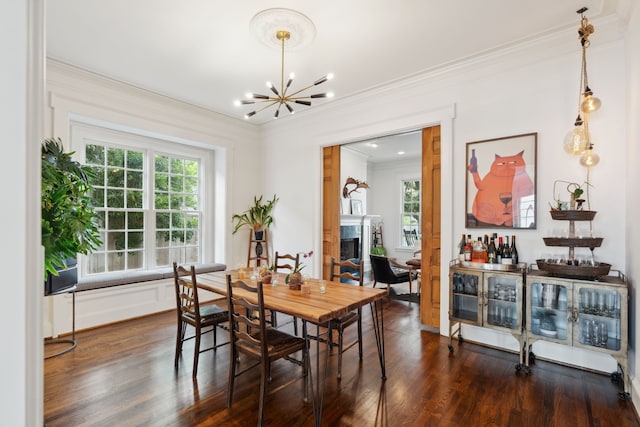 613 E 18th St, Houston, TX 77008 - dining room with crown molding, a fireplace, a chandelier, and dark wood-style flooring