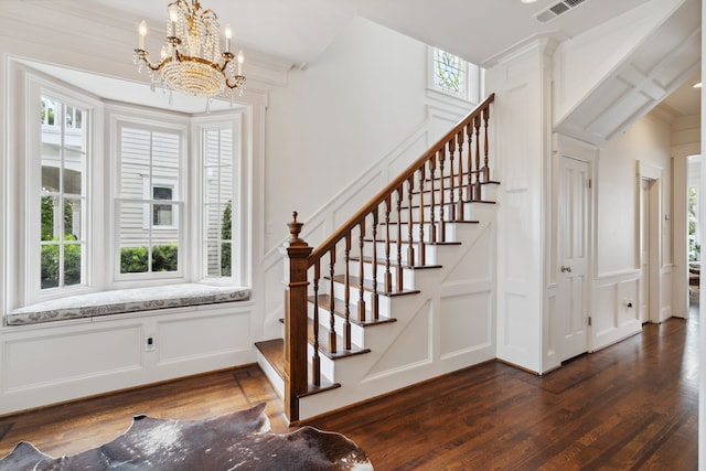 613 E 18th St, Houston, TX 77008 - stairway with a decorative wall, wood finished floors, a chandelier, crown molding, and wainscoting
