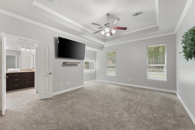 532 County Road 632, Dayton, TX 77535 - unfurnished bedroom featuring a raised ceiling, light colored carpet, multiple windows, ornamental molding, and baseboards