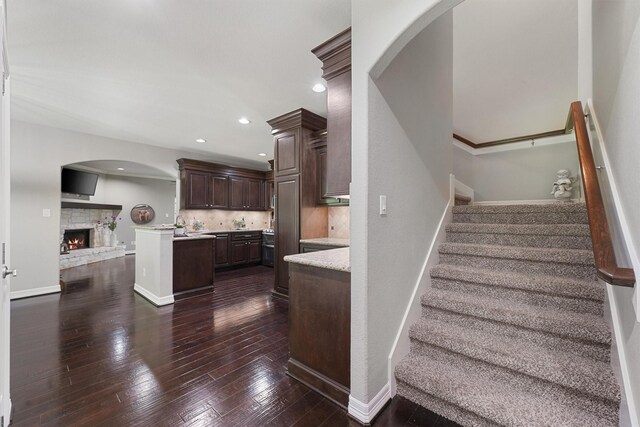 532 County Road 632, Dayton, TX 77535 - stairway featuring hardwood / wood-style floors, a fireplace, recessed lighting, baseboards, and arched walkways