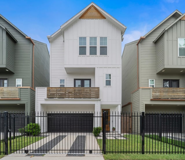 1503 Evelyn St, Houston, TX 77009 - view of front of house featuring board and batten siding, a balcony, a garage, and a fenced front yard