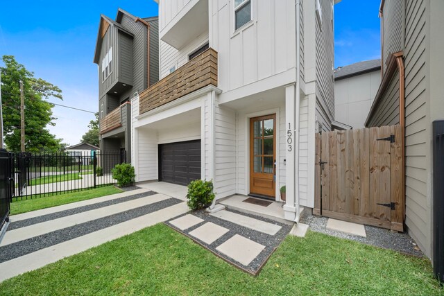 1503 Evelyn St, Houston, TX 77009 - view of front of house with board and batten siding, a garage, and driveway