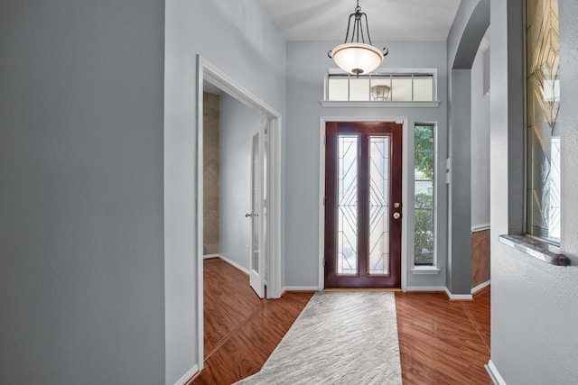 2723 Shelby Dr, Pearland, TX 77584 - foyer entrance with wood finished floors, arched walkways, and baseboards