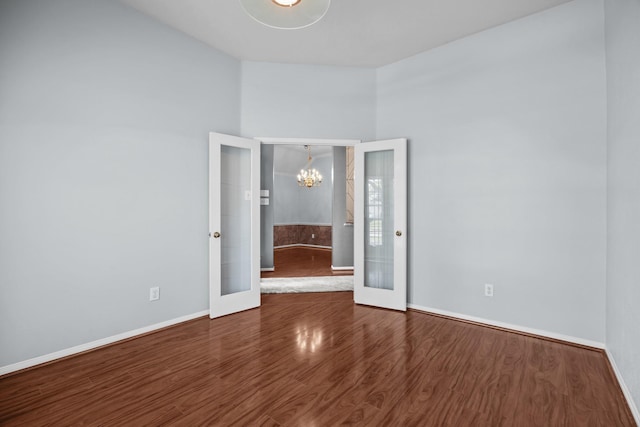 2723 Shelby Dr, Pearland, TX 77584 - empty room with french doors, a chandelier, baseboards, and wood finished floors