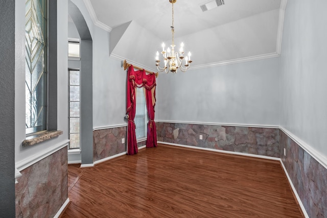 2723 Shelby Dr, Pearland, TX 77584 - unfurnished dining area with crown molding, arched walkways, wood finished floors, a chandelier, and baseboards