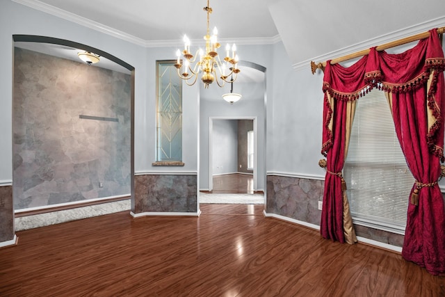 2723 Shelby Dr, Pearland, TX 77584 - unfurnished room featuring arched walkways, a chandelier, wood finished floors, a wainscoted wall, and ornamental molding