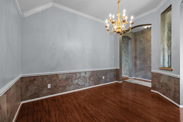 2723 Shelby Dr, Pearland, TX 77584 - spare room featuring arched walkways, wood finished floors, a wainscoted wall, a chandelier, and crown molding