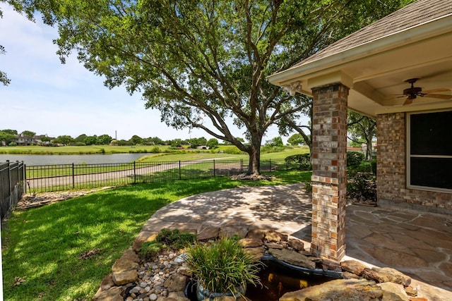 2723 Shelby Dr, Pearland, TX 77584 - view of yard featuring ceiling fan, a patio area, and a water view