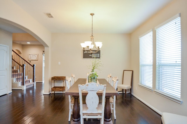 2109 Sunset Terrace Ln, Houston, TX 77089 - dining room with a chandelier, arched walkways, stairs, hardwood / wood-style flooring, and baseboards