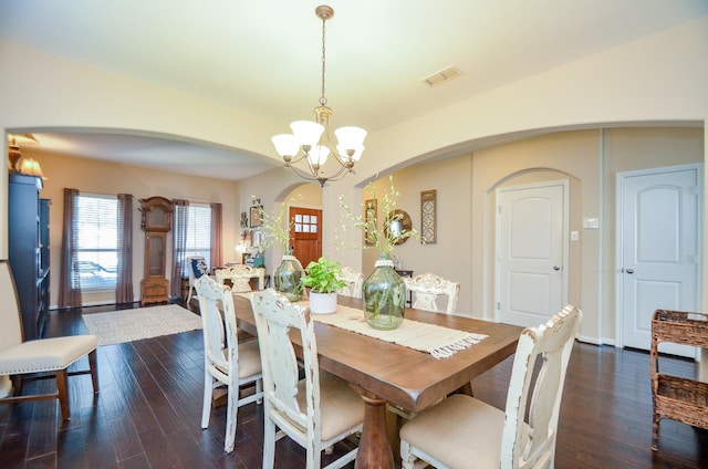 2109 Sunset Terrace Ln, Houston, TX 77089 - dining room featuring arched walkways, a chandelier, dark wood-style floors, and baseboards