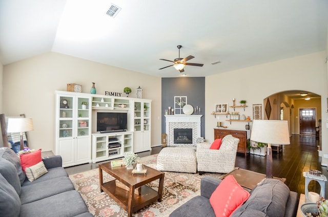 2109 Sunset Terrace Ln, Houston, TX 77089 - living area featuring arched walkways, ceiling fan, dark wood-type flooring, and a tiled fireplace