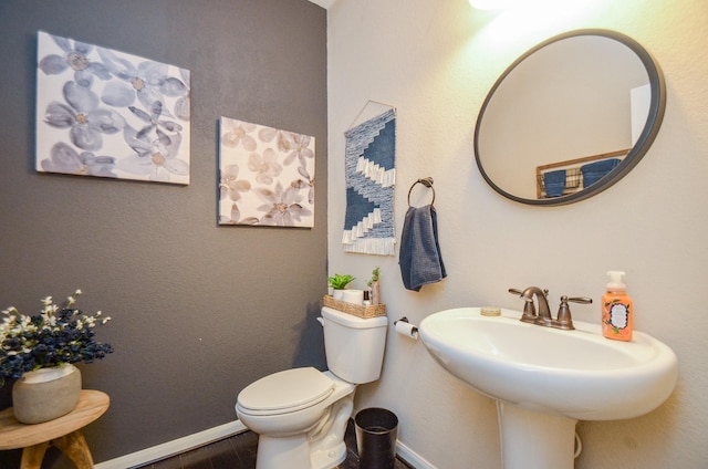 2109 Sunset Terrace Ln, Houston, TX 77089 - half bathroom with baseboards, toilet, and wood finished floors