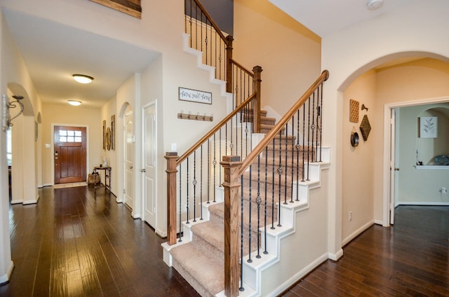 2109 Sunset Terrace Ln, Houston, TX 77089 - foyer entrance featuring dark wood-style flooring, stairway, baseboards, and arched walkways