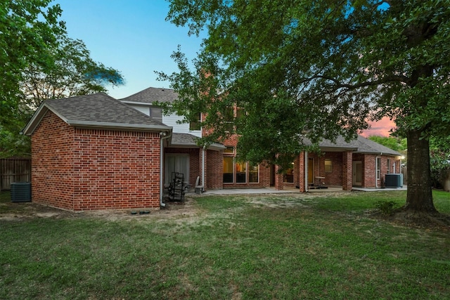 9707 Chipstead Cir, Spring, TX 77379 - back of property with cooling unit, brick siding, roof with shingles, and a patio